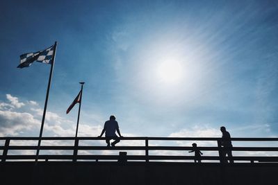 Low angle view of silhouette man against sky