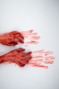 Cropped hand of woman with powder paint against white background