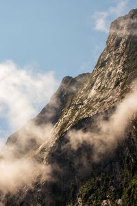 Cloud by mountain against sky