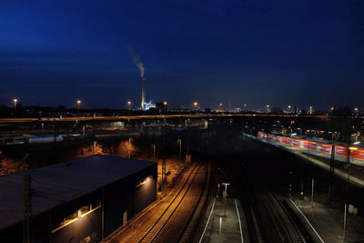 High angle view of railroad tracks against sky at night