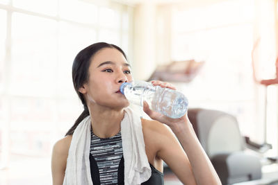 Portrait of young woman drinking glass