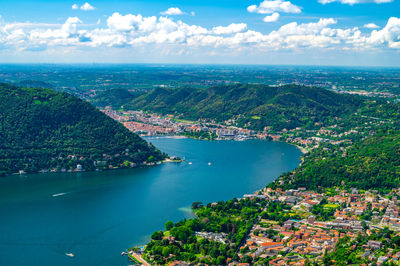 High angle view of townscape by sea against sky