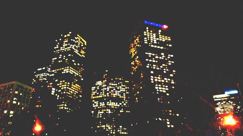 Low angle view of skyscrapers lit up at night