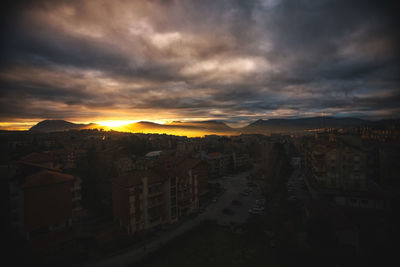 High angle view of buildings in city at sunset