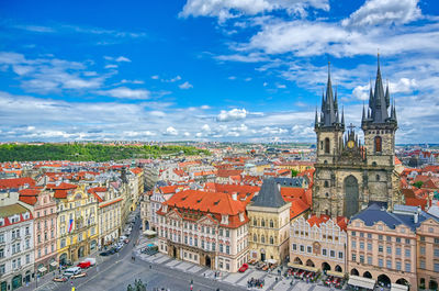 Aerial view of townscape against cloudy sky