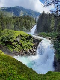 Scenic view of waterfall against sky