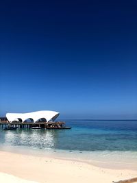 Scenic view of sea against clear blue sky