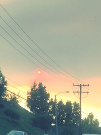 Low angle view of electricity pylon against sky