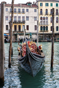 Boats in canal along buildings