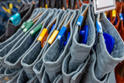 Close-up of jeans hanging for sale at store