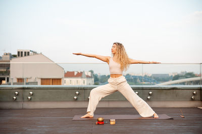 Full length of young woman exercising in gym