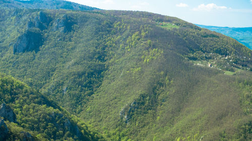 High angle view of land and mountains against sky