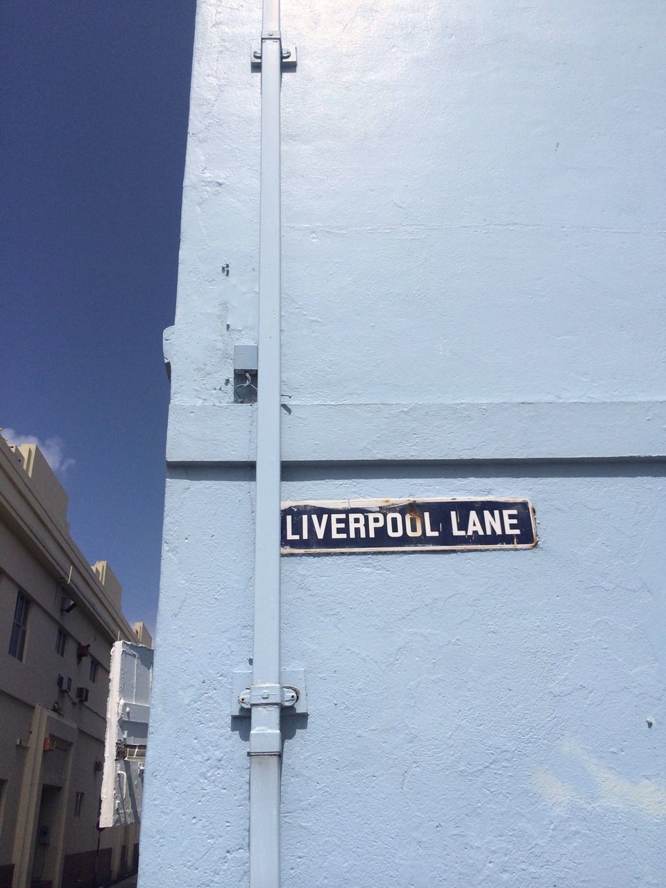 architecture, built structure, building exterior, text, communication, low angle view, guidance, western script, information sign, sign, wall - building feature, information, safety, day, direction, road sign, clear sky, building, no people, outdoors