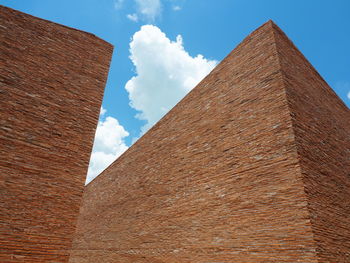 Low angle view of building against cloudy sky