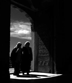 Nuns walking at entrance doorway of church