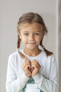Portrait of a smiling girl over white background