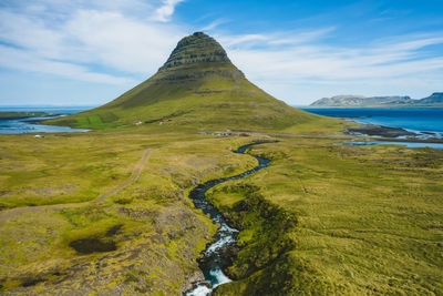 Scenic view of sea and mountains against sky