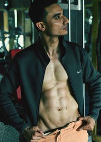 Muscular man standing at gym