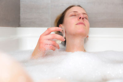 Midsection of woman in bathroom at home