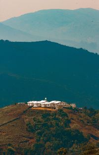 High angle view of houses on mountain peak against sky