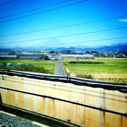 View of railway tracks against blue sky