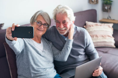 Woman using mobile phone at home