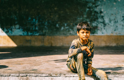 Boy sitting outdoors