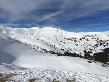 Scenic view of snow covered mountains against sky