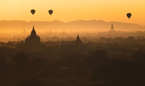 Hot air balloons against sky during sunset