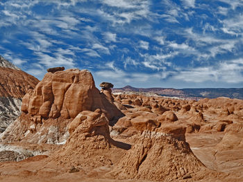 Scenic view of rocky mountains against cloudy sky