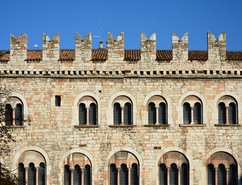 Low angle view of historical building against clear blue sky