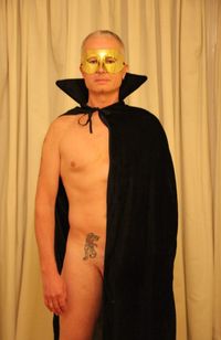 Midsection of shirtless man standing against wall