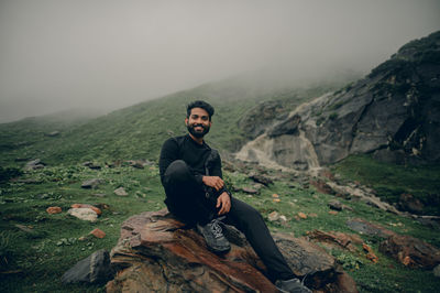 Portrait of man standing on rock