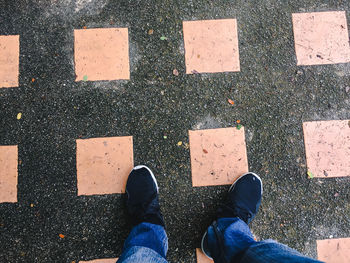 Low section of man standing on floor in city