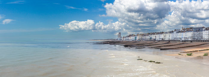 Panoramic view of beach and seafront against sky