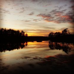 Scenic view of lake against romantic sky at sunset
