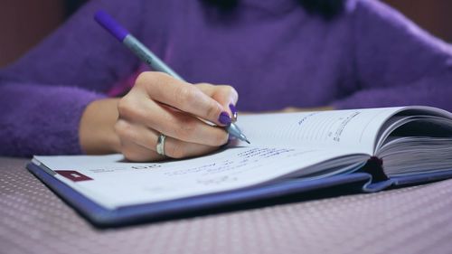 Close-up of woman writing