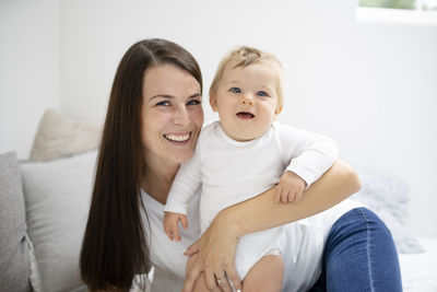 Portrait of mother and daughter at home