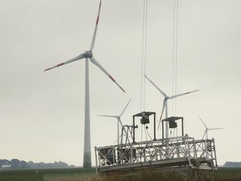 Low angle view of windmills against clear sky