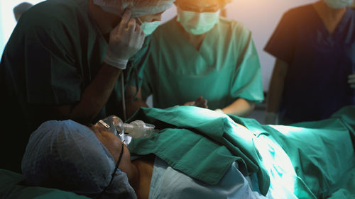 High angle view of doctor examining patient at clinic