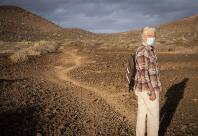 Rear view of man standing on road