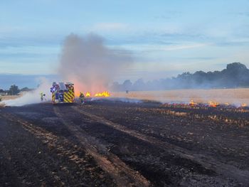 Scenic view of field against sky during sunset fieldfire firefighter 