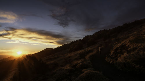 Scenic view of mountains against dramatic sky