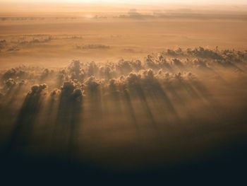 Aerial view of landscape against sky during sunset