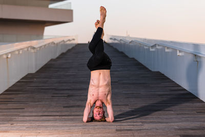 Full length of woman standing on pier