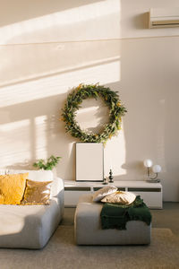 Christmas interior of a scandinavian modern living room. sofa and wreath on the wall