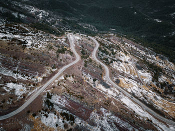High angle view of mountain road against land and forest
