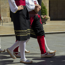 Low section of people standing on street