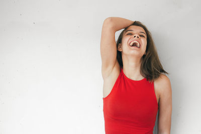 Smiling young woman against white background