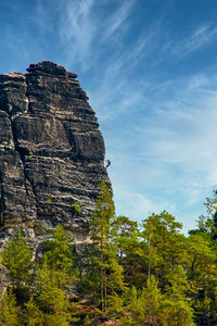 Sandstone rock formation the locomotive in german-saxon switzerland with a climber on the right side